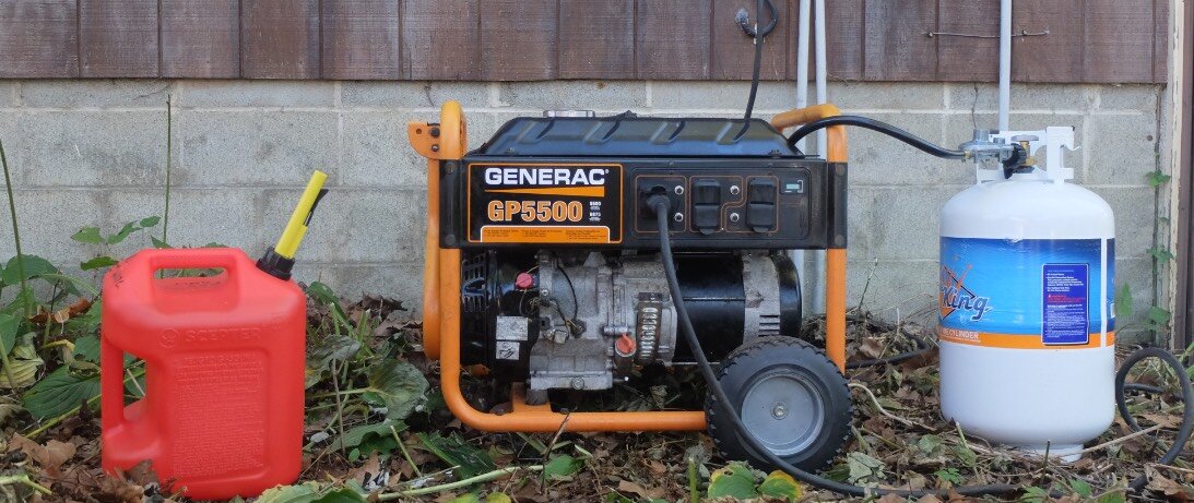 After research and work, I made my old generator, in the center able to run on gasoline (ethanol-free, at left) or as hooked up here on propane, which in most respects is better, It is connected by a thick cable to the transfer socket, so it can power my house when needed. (Credit: Dennis E. Powell)